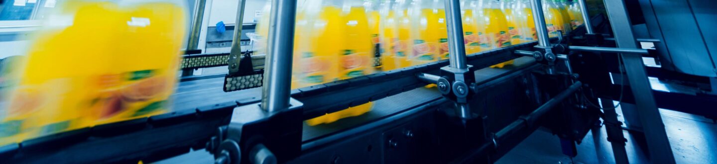 Beverage factory interior. Conveyor with bottles for juice or water. Modern equipment - Financial Reporting