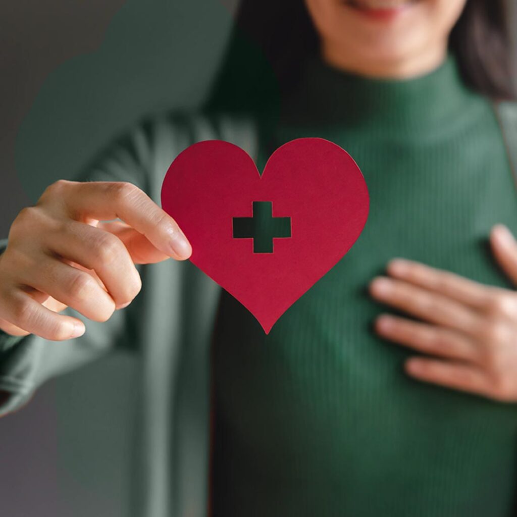 Woman with a paper heart - Nonprofit Accounting and Consulting Services | Brady Ware