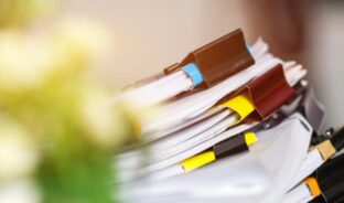stacks of clipped together files - Assurance, Financial Integrity and Risk Mitigation